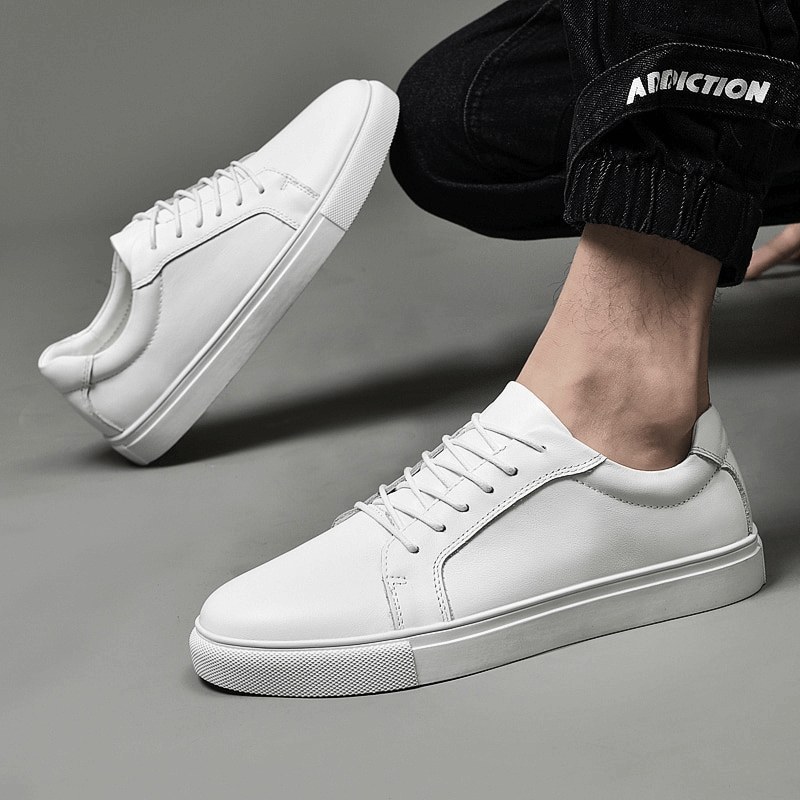 Stylish men's sports leather sneakers with flat sole and lace-up design, featuring massage insole for comfort and rubber outsole for secure fit.